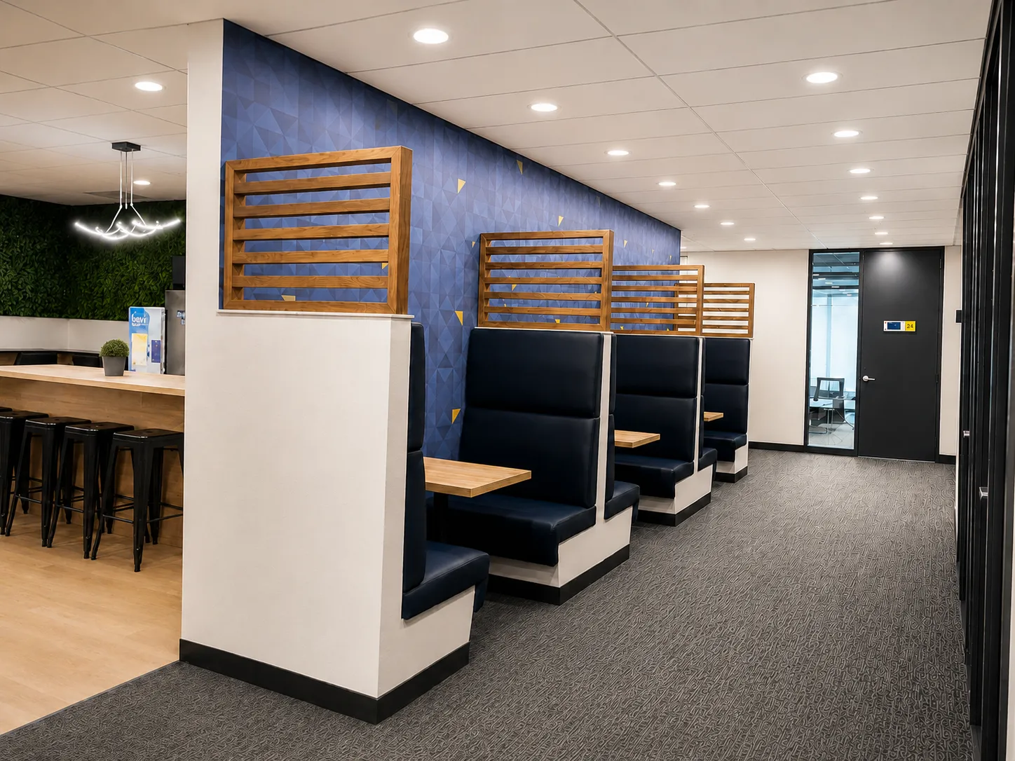 Hallway of booths leading to a glass-doored private office suite